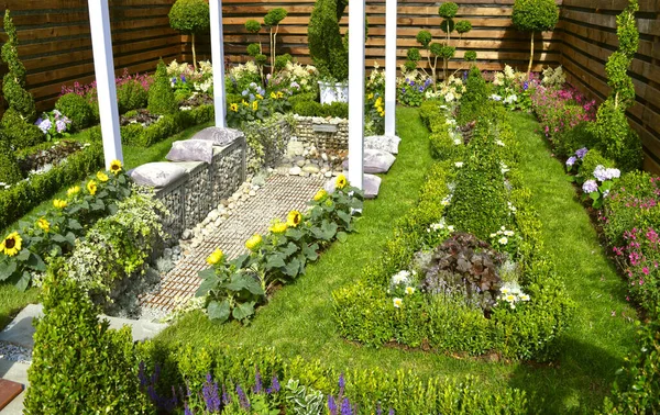 Cottage garden with a water feature and flowerbeds