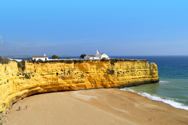 The Chapel of Nossa Senhora da Rocha  on top of the spectacular cliffs on Nova Beach in Portugal