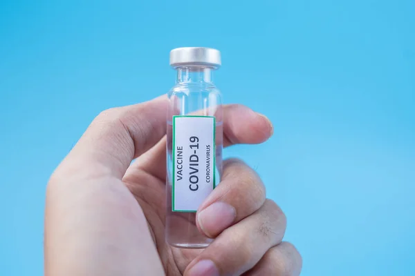 COVID-19 Vaccine vial against Coronavirus infection in hand of docto in hospital laboratory. Medical, health, Vaccination and immunization concept