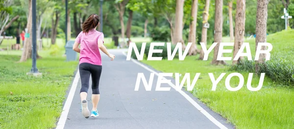 New Year New You with Young woman running in the park outdoor, asian Athlete jogging and exercise on the road in morning. Fitness, wellness, healthy lifestyle, resolution and New Start concepts