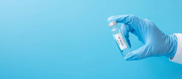 COVID-19 Vaccine vial against Coronavirus infection in hand of doctor with Nitrile Glove in hospital laboratory. Medical, health, Vaccination and immunization concept