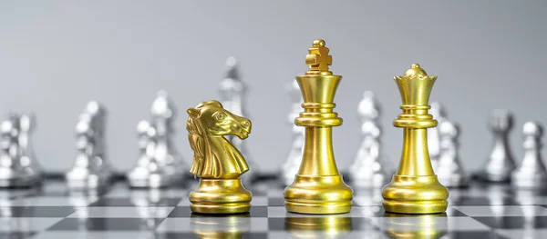 Gold Chess figure team (King, Queen, Bishop, Knight, Rook and Pawn) on Chessboard against opponent during battle. Strategy, Success, management, business planning, think, education and leader concept