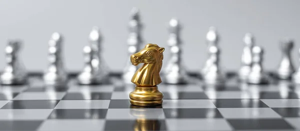 Gold  Chess Knight (horse) figure on Chessboard against opponent or enemy. Strategy, Conflict, management, business planning, tactic, politic, communication and leader concept