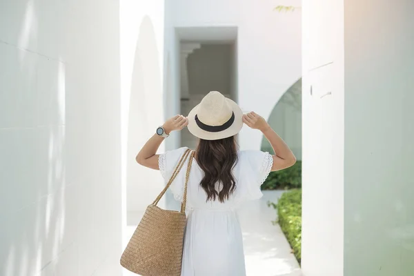 Happy traveler woman in white dress and hat enjoy in holiday time. Southeast Asia travel, trip and summer vacation concept