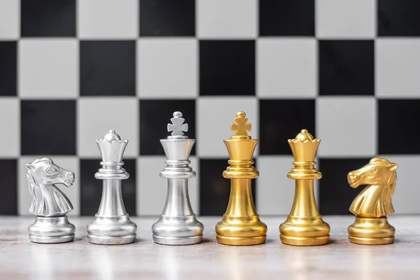 Gold and silver Chess figure on Chessboard against opponent or enemy. Strategy, Conflict, management, business planning, tactic, politic, communication and leader concept