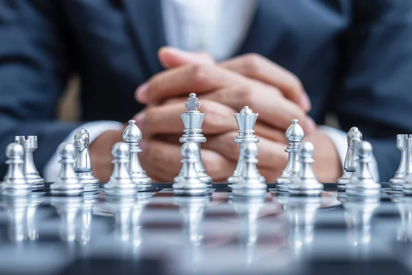 Chess figure team (King, Queen, Bishop, Knight, Rook and Pawn) with businessman manager background. Strategy, Success, management, business planning, tactic, thinking, vision and leader concept