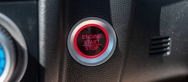 a car ignition button or START engine inside modern electric automobile. Keyless, change, strategy, vision, innovation and future concept