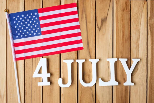 7月4日のテキストとアメリカ合衆国の木製のテーブルの背景にフラグを立てます アメリカの独立とお祝いの概念の休日 — ストック写真