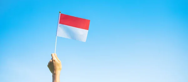 Mano Che Tiene Bandiera Indonesiana Sfondo Cielo Blu Indonesia Giorno — Foto Stock