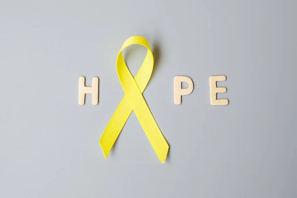 Childhood Cancer, Sarcoma, bone, bladder and Suicide prevention Awareness month, Gold Yellow Ribbon for supporting people living and illness. children Healthcare and World cancer day concept