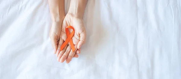 Leukemia, Kidney cancer day, world Multiple Sclerosis, CRPS, Self Injury Awareness month, Orange Ribbon for supporting people living and illness. Healthcare and World cancer day concept