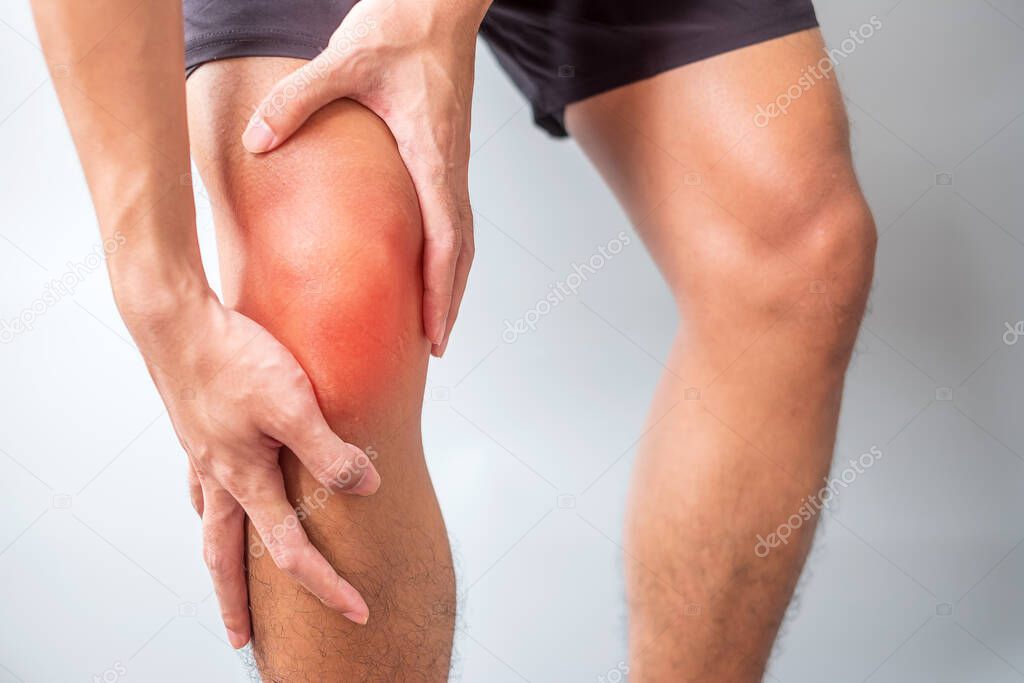 man with muscle pain on grey background. Elderly have knee ache due to Runners Knee or Patellofemoral Pain Syndrome, osteoarthritis, arthritis, rheumatism and Patellar Tendinitis. medical concept
