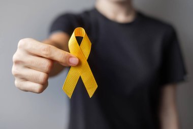 Suicide prevention day, Sarcoma, bone, bladder and Childhood cancer Awareness month, Yellow Ribbon for supporting people living and illness. children Healthcare and World cancer day concept clipart
