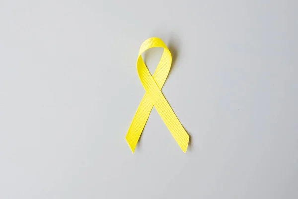 Childhood Cancer, Sarcoma, bone, bladder and Suicide prevention Awareness month, Gold Yellow Ribbon for supporting people living and illness. children Healthcare and World cancer day concept
