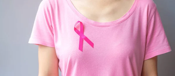 October Breast Cancer Awareness month, elderly Woman in pink T- shirt with Pink Ribbon for supporting people living and illness. International Women, Mother and World cancer day concept