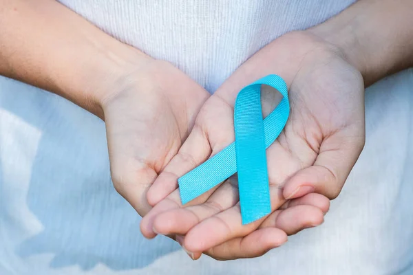 November Prostate Cancer Awareness month, woman holding Blue Ribbon for supporting people living and illness. Healthcare, International men, Father, World cancer day and world diabetes day concept