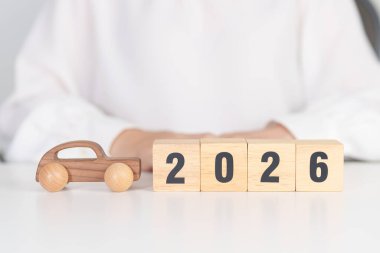 Happy New Year 2026 with Car model on table. Automobile Tax, Car Insurance, Financial, vehicle Repair and Maintenance and New Year concept