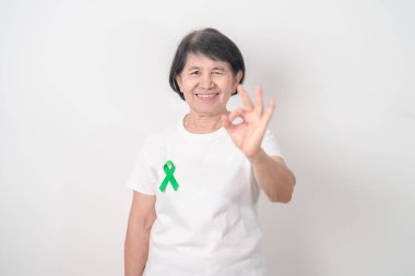 Temmuz Göz Sakatlığını Önleme Ayı, Ocak Glaucoma Bilinç Ayı, Şubat Safra kesesi ve Bile kanalı ve Ekim Karaciğer Kanseri konsepti için Yeşil Kurdele sahibi yaşlılar. Sağlık ve Dünya Kanser Günü