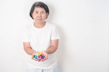 Dünya Kanser Günü, 4 Şubat. Renkli kurdeleli yaşlılar, mavi, sarı, kırmızı, yeşil, beyaz, pembe ve gri, yaşayan ve hastalıklı insanları desteklemek için. Sağlık, Sağlık, Farkındalık ve Sigorta kavramı