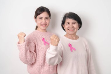 Pembe Ekim Kanser Bilinci ayı için pembe kurdeleli çift, Mayıs Kadın Sağlığı, Kasım Doğum Ebeveynleri Evlat Edinme, Kadın Hakları, Yetkilendirme, Mart Uluslararası Kadınlar Günü ve Kanser Günü