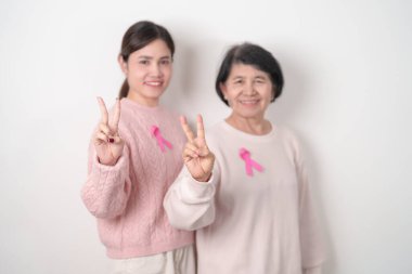 Pembe Ekim Kanser Bilinci ayı için pembe kurdeleli çift, Mayıs Kadın Sağlığı, Kasım Doğum Ebeveynleri Evlat Edinme, Kadın Hakları, Yetkilendirme, Mart Uluslararası Kadınlar Günü ve Kanser Günü