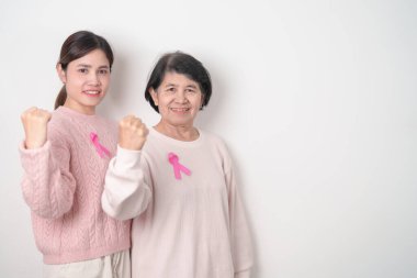 Pembe Ekim Kanser Bilinci ayı için pembe kurdeleli çift, Mayıs Kadın Sağlığı, Kasım Doğum Ebeveynleri Evlat Edinme, Kadın Hakları, Yetkilendirme, Mart Uluslararası Kadınlar Günü ve Kanser Günü