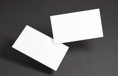 Yüzen İş Kartı Model 'i. Siyah arkaplanın önünde havada süzülen iki boş kartvizit var.