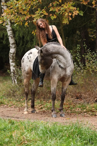 Beautiful girl riding a horse without bridle or saddle — Stock Photo, Image