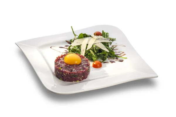 Delicious Steak tartar with yolk and rocket salad ready to serve — Stock Photo, Image