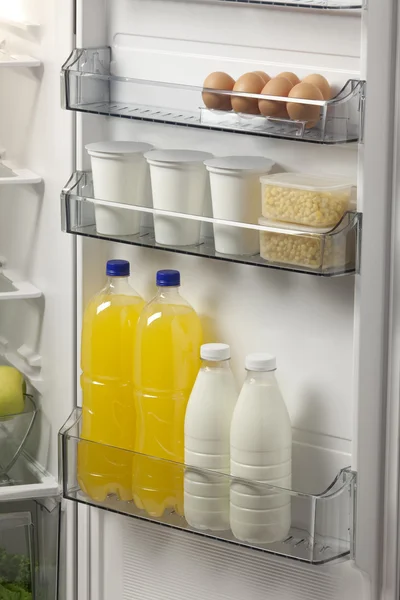 Opened refrigerator full of foodstuff and drinks — Stock Photo, Image