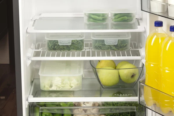 Fruits and vegetables in two containers in a modern fridge - a h — Stock Photo, Image