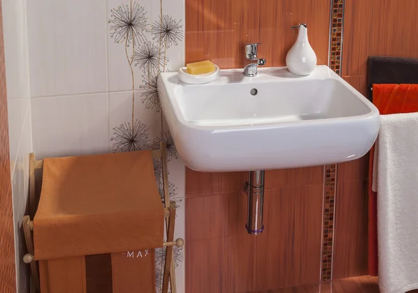 detail of modern private bathroom interior in orange with sink