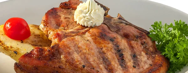 Roasted pork steak garnished with cherry tomatoes and cream — Stock Photo, Image