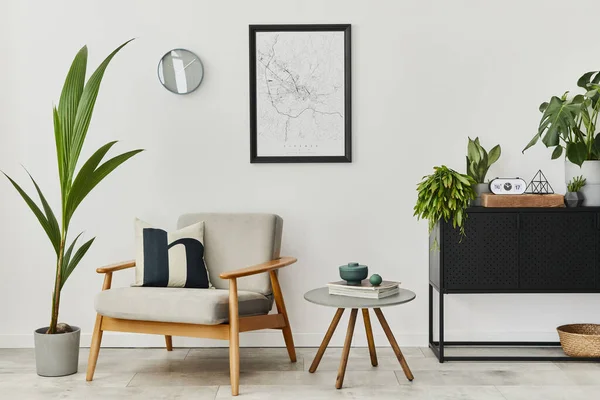 Modern retro concept of home interior with design grey armchair, coffee table, plants, mock up poster map, carpet and personal accessories. Stylish home decor of living room.