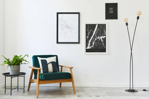 Retro and minimalist compositon of living room interior with design armchair, two mock up poster map, lamp, decoration, white wall and personal accessories. Template. Modern home decor.