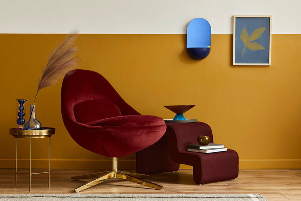Unique living room in modern style interior with mock up poster frame,  design red velvet armchair,  elegant furniture, decoration and pesronal accessories in home decor. Honey yellow wall. Template.