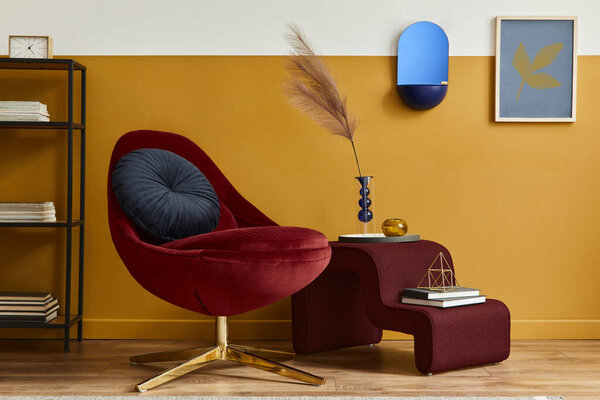 Unique living room in modern style interior with mock up poster frame,  design red velvet armchair,  elegant furniture, decoration and pesronal accessories in home decor. Honey yellow wall. Template.