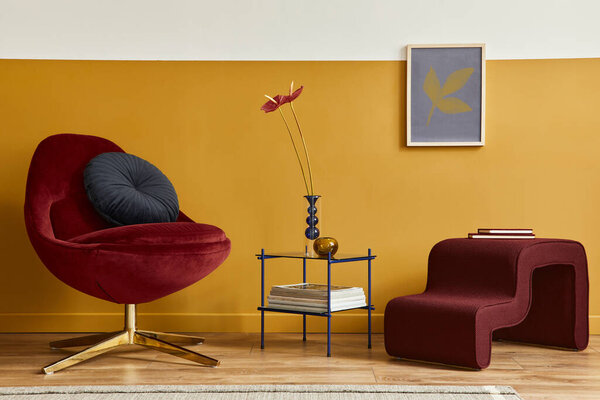 Unique living room in modern style interior with mock up poster frame,  design red velvet armchair,  elegant furniture, decoration and pesronal accessories in home decor. Honey yellow wall. Template.