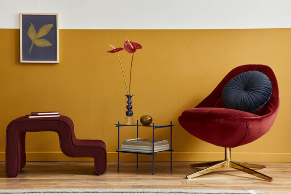 Unique living room in modern style interior with mock up poster frame, design red velvet armchair, elegant furniture, decoration and pesronal accessories in home decor. Honey yellow wall. Template.