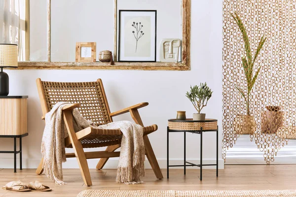 Unique living room interior with stylish rattan armchair,  design furniture, dried flowers, mock up poster frames,  wooden floor, decoration and elegant personal accessories. Modern home. Template.