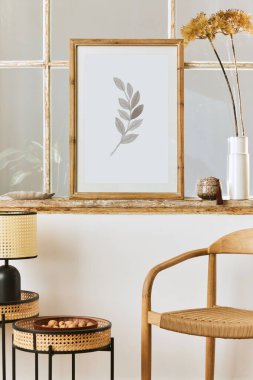 Tasarım koltuğu, kahve masası, eski pencere, vazoda kurumuş çiçekler, kahverengi poster çerçevesi, dekorasyon ve zarif kişisel aksesuarlarla modern oturma odası kompozisyonu. Şablon.