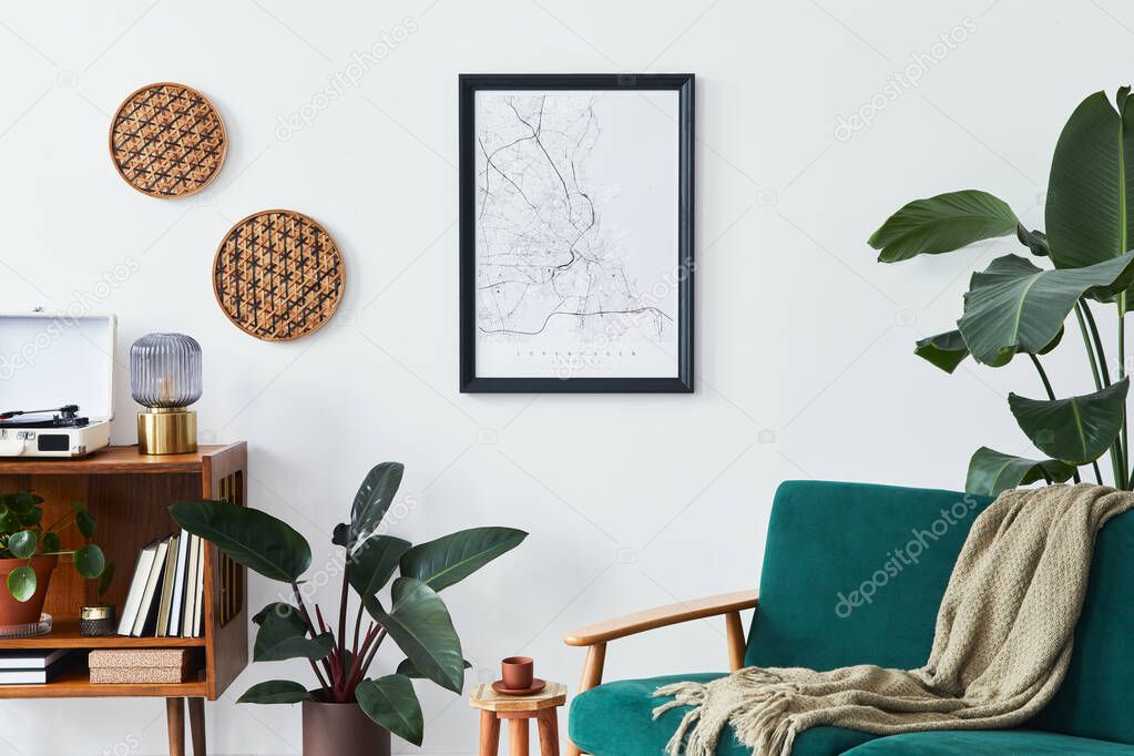 Stylish interior of living room with design wooden shelf, velvet sofa, a lot of plants, mock up poster map, vinyl recorder, book and personal accessories in vintage home decor. Template.