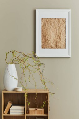 Stylish interior of dining room at cozy home with white mock up poster frame, design wooden shelf, decoration, flowers, book and elegant personal accessories in modern home decor. Template.