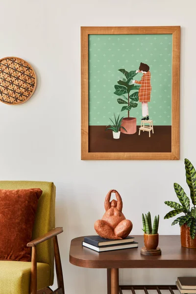 Minimalist composition of living room with brown mock up picture frame, plant, retro armchair, dried tropical leaf, decoration and elegant personal accessories in stylish home decor. Template.