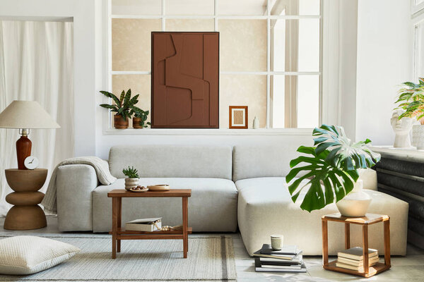 Creative composition of stylish and cozy living room interior with mock up structure painting, grey corner sofa, window, coffee table and personal accessories. Beige neutral colors. Template.