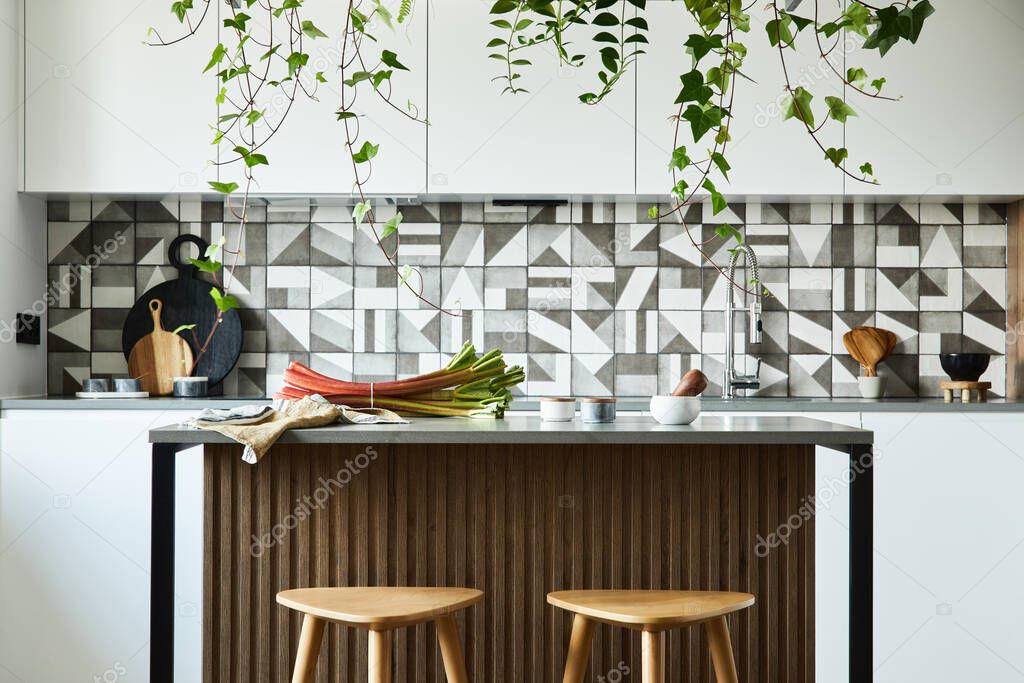 Stylish kitchen interior design with dining space. Workspace with kitchen accessories on the back ground. Creative walls. Minimalistic style an plant love concept. 