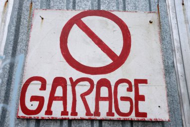 Beyaz arka planda paslı metal tabelası