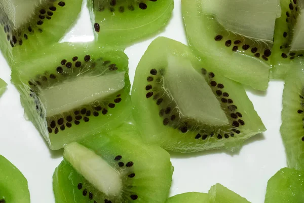Close up of fresh kiwi fruit cubes, isolated on white — Zdjęcie stockowe