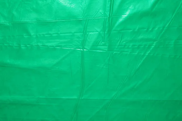 Crumpled wavy green polyethylene garbage bags pattern