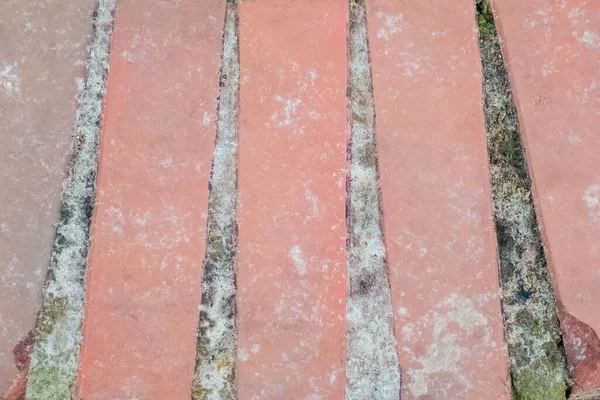 Patterned long vertical red brickwork with sand and moss in the seams — Stock Photo, Image